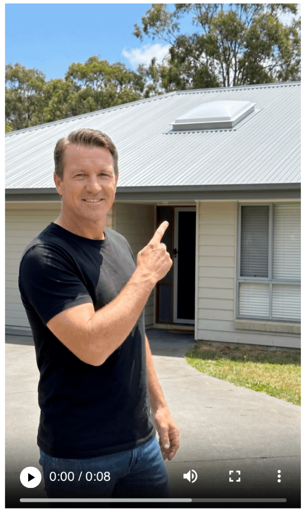 Man pointing at square skylight dome on the roof